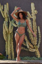 Front view of model wearing Minaret Sport Top in agave color