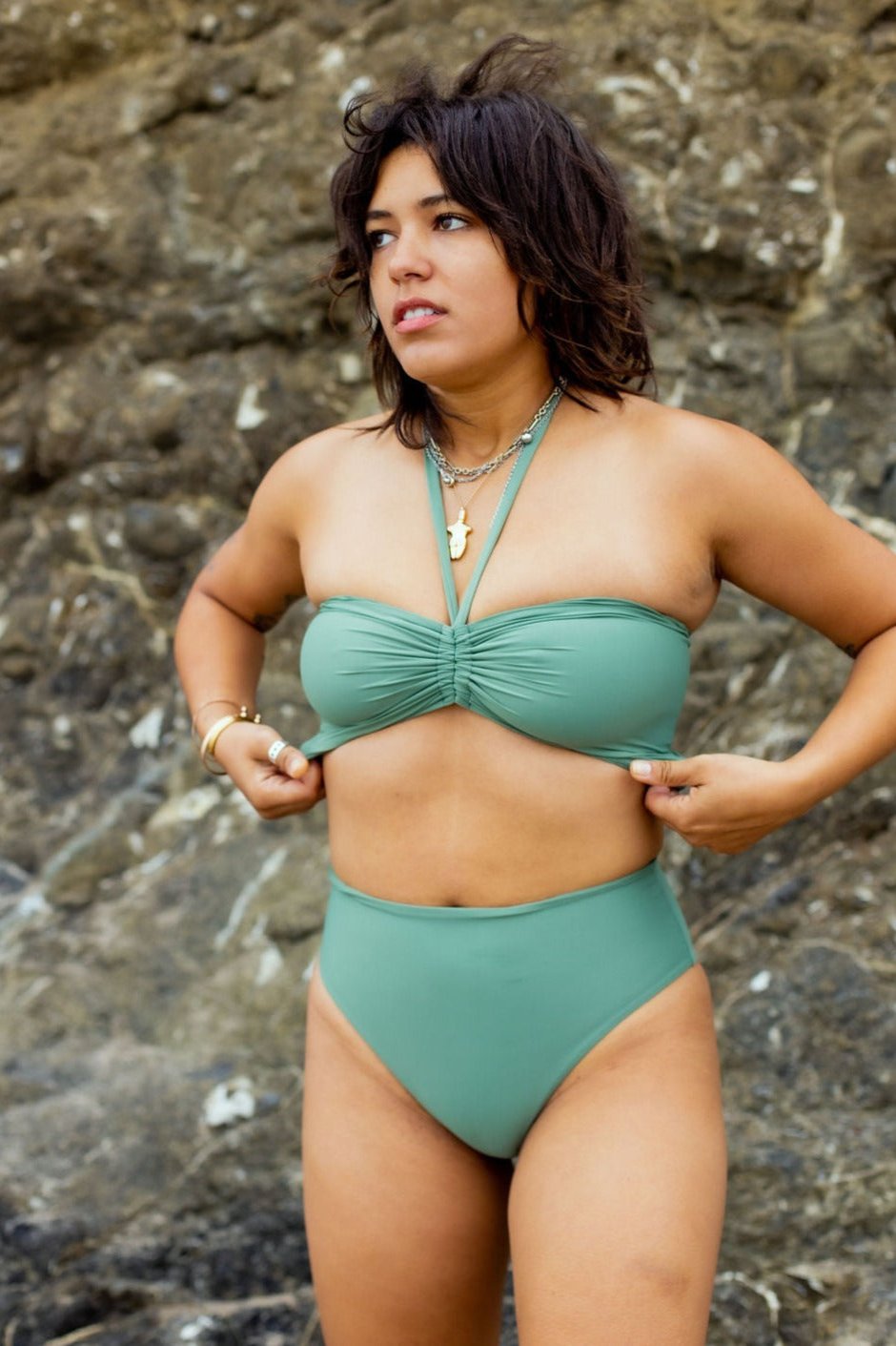 Model wearing the Isla Bandeau top in agave color styled as a halter top